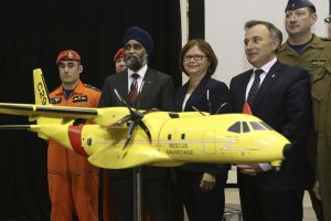 LARS HAGBERG / THE CANADIAN PRESS Defence Minister Harjit Sajjan, third left, Public Procurement Minister Judy Foote and the MP Neil Ellis, second right, for Bay of Quinte pose for pictures at CFB Trenton in Trenton, Ontario, on Thursday Dec. 8, 2016. The federal government says Canada will spend $2.3 billion to replace the military's ancient search-and-rescue planes with 16 new aircraft from European aerospace giant Airbus.